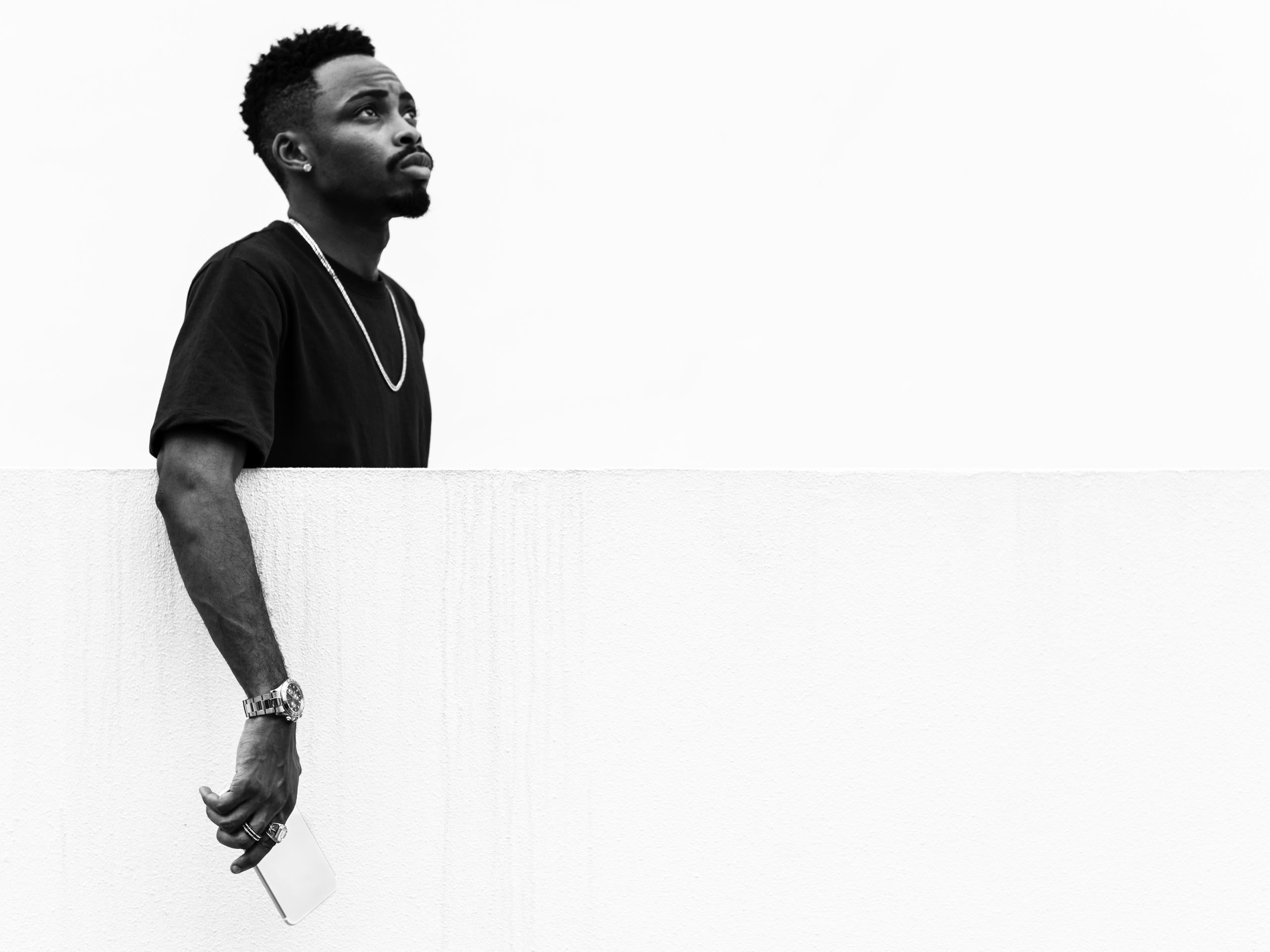 Black and white portrait of a person holding a whiteboard